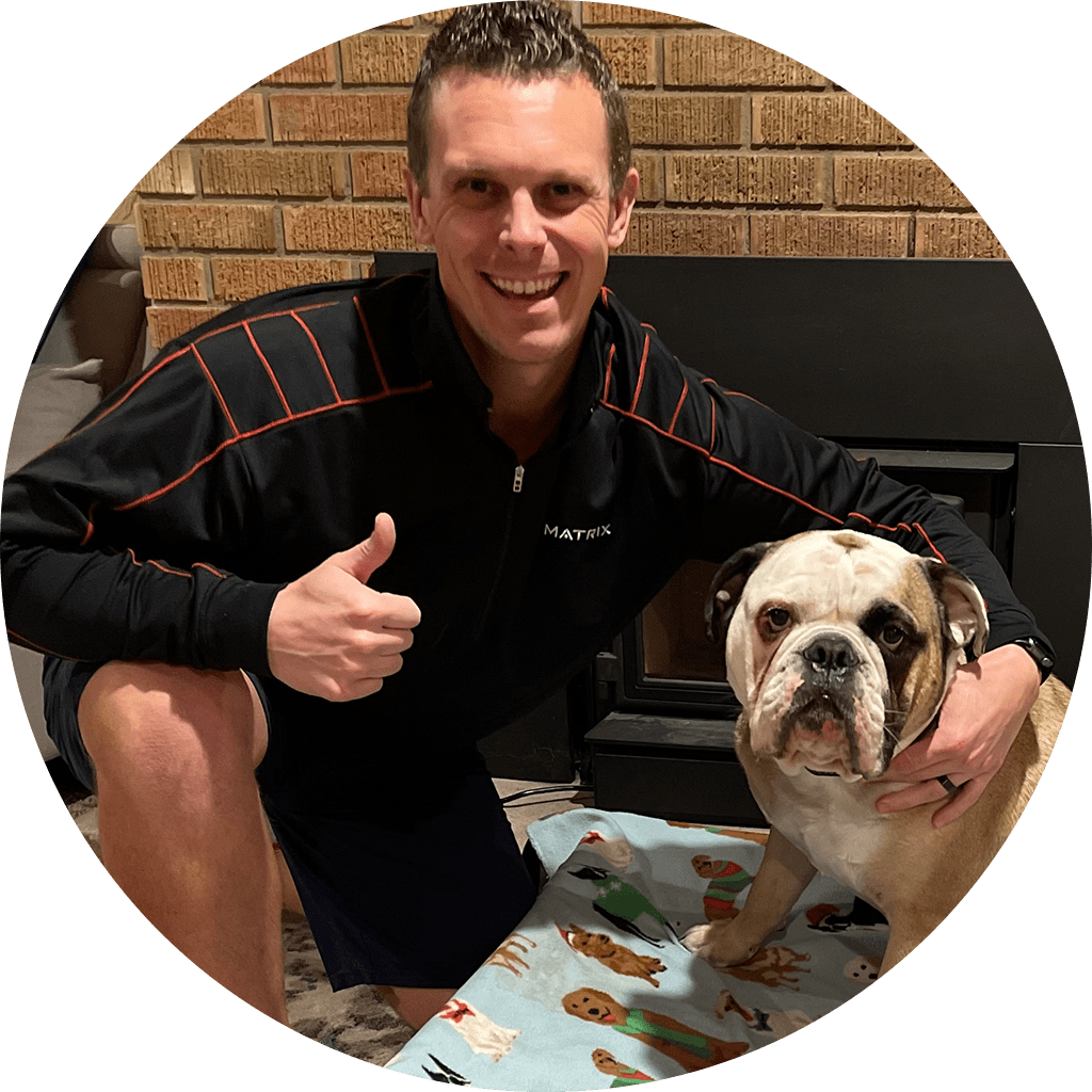 Ben Wanezek Bulldog Fitness LLC Personal Trainer kneeling with arm around with family bulldog Winston