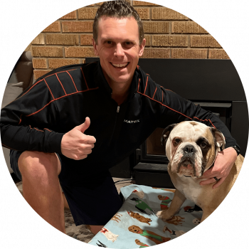 Ben Wanezek Bulldog Fitness LLC Personal Trainer kneeling with arm around with family bulldog Winston